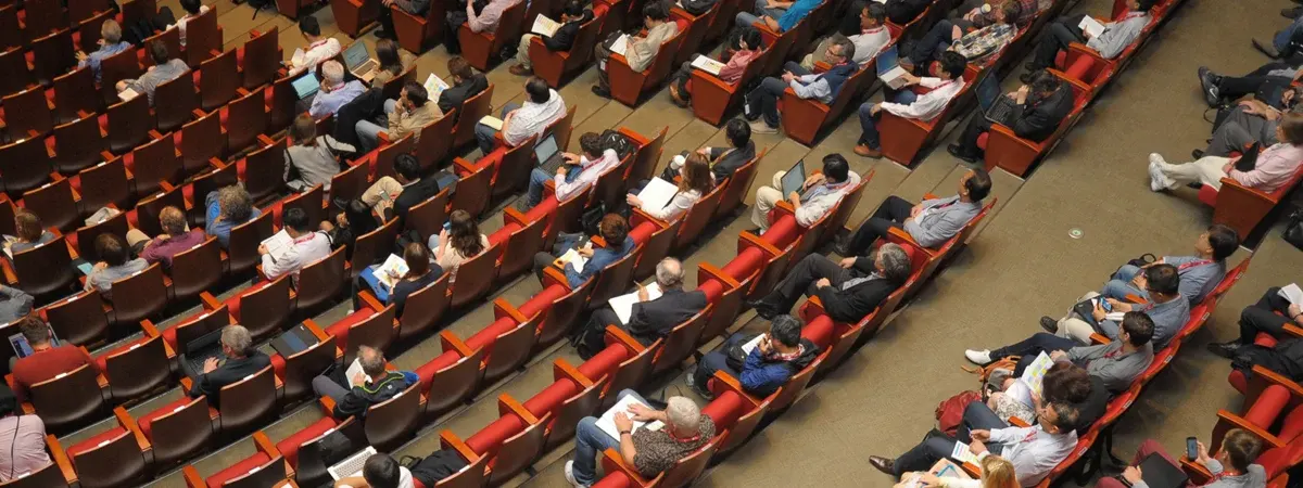 Conference audience seated in rows facing the stage