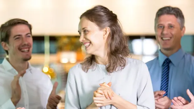 Group of business people laughing together at a networking event