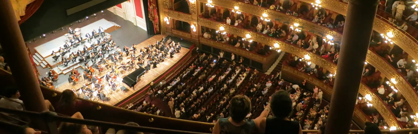 Orchestra hall with balconies filled with audience