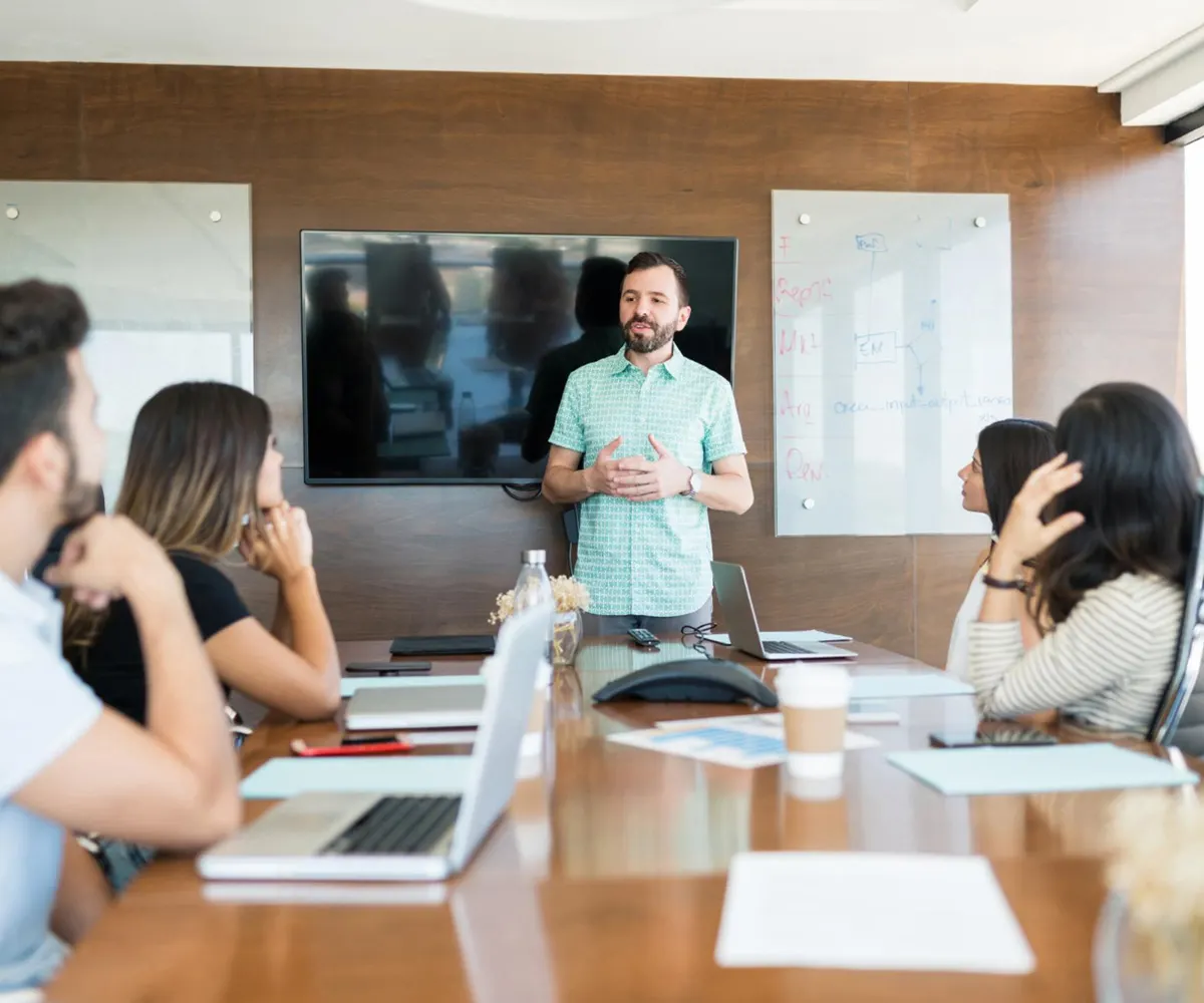 Marketing team listening to a speaker in a meeting room