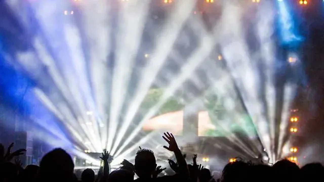 Audience in front of a stage with bright lights